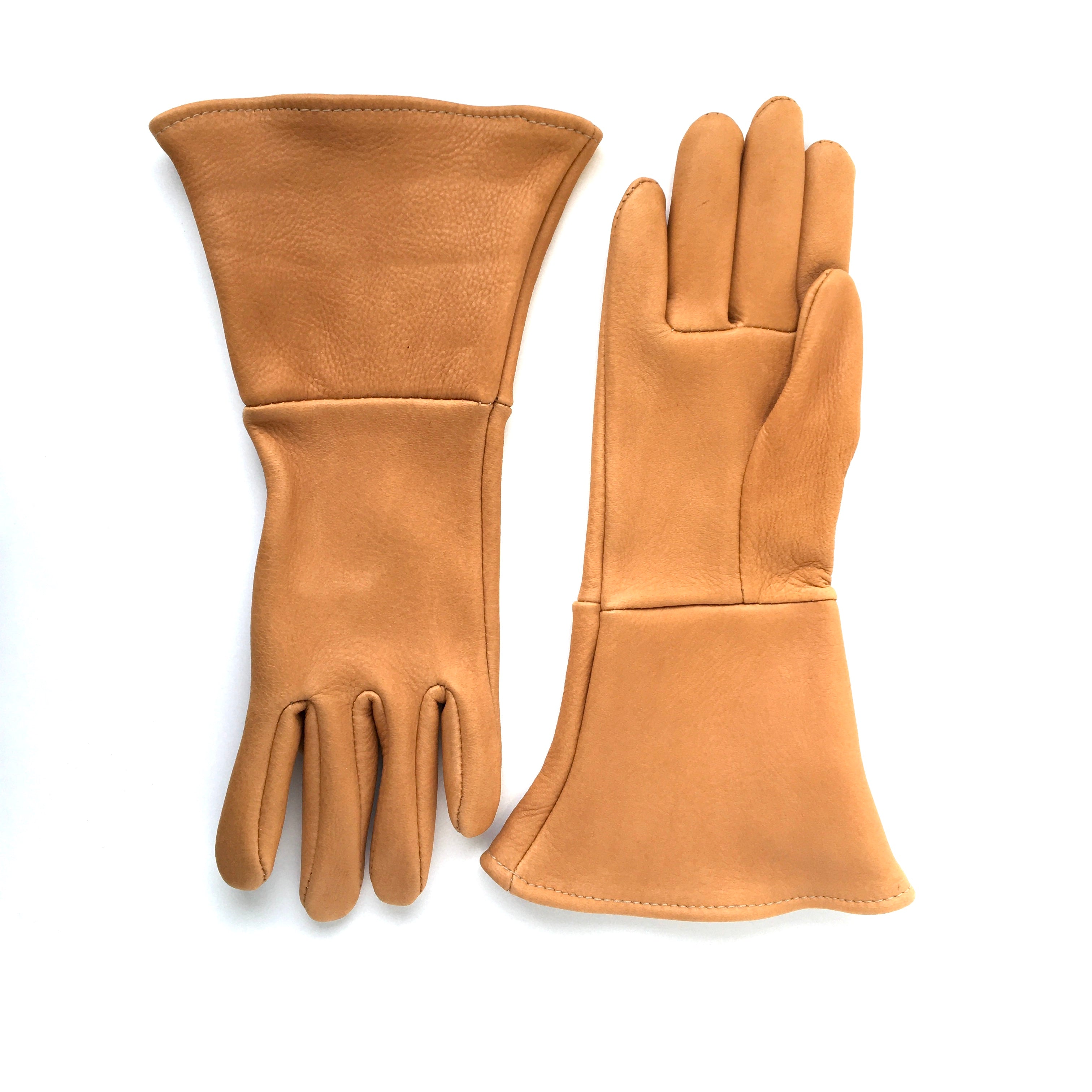 A pair of deerskin gauntlets top view showing extended cuff saddle tan leather