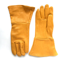 Load image into Gallery viewer, A pair of deerskin gauntlets top view showing extended cuff gold leather