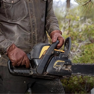 Man holding chainsaw using Bison Leather Gloves Made in USA man working with buffalo leather gloves