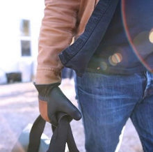 Load image into Gallery viewer, Man in blue jeans wearing black 80th anniversary leather gloves made in USA