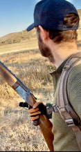 Load image into Gallery viewer, Man holding shot gun hunting pheasant wearing a deerskin hunting shorty made in the USA