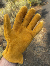 Load image into Gallery viewer, A single green-gold leather glove worn on a person's hand, photographed outdoors on a dirt path with dry brush in the background.