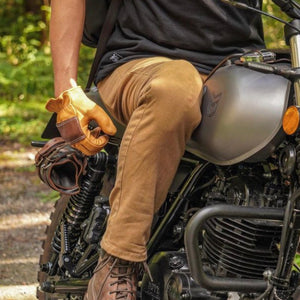 Man on motorcycle wearing USA made 80th anniversary saddle tan shorty